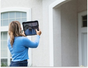 Agent Taking Photos Female real estate agent taking photos of a property
