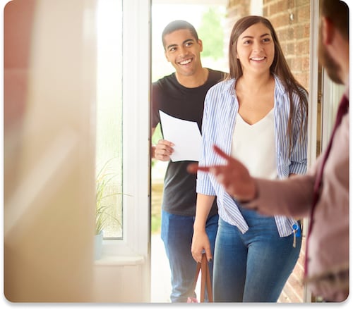 Showing agent opening the door to potential home buyers