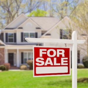 For Sale Sign in Front of Home For sale sign in front of a home.
